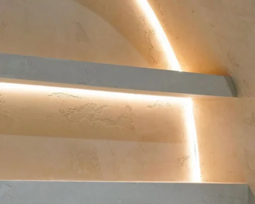 Textured Venetian plaster wall in Newcastle with a warm tone and subtle lighting highlighting its elegant finish 1